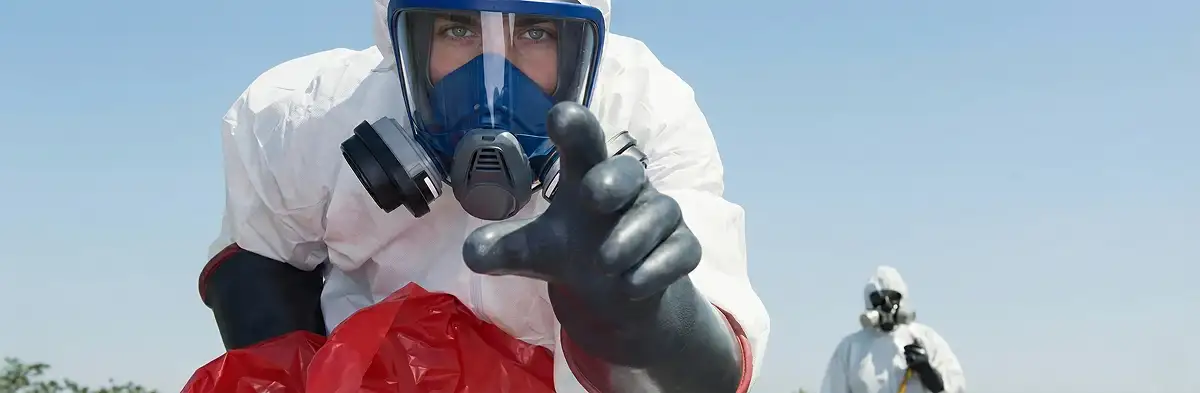 sewage clean up technician wearing protective gear handling biohazard materials in Ogden, UT